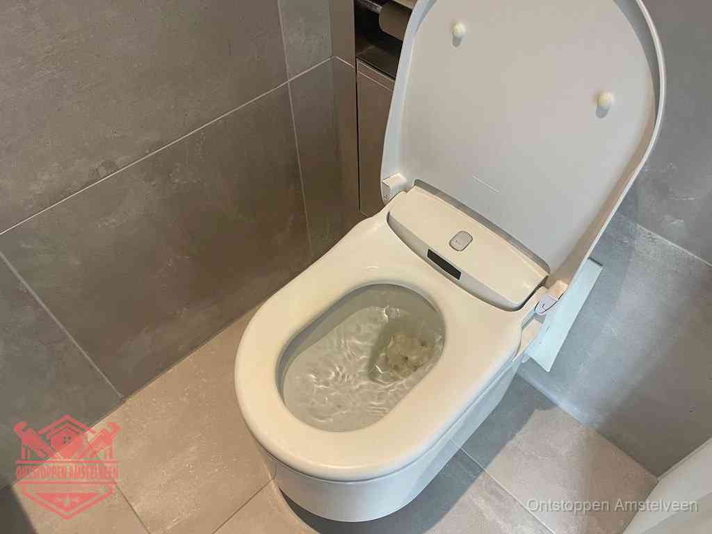 Een toiletpot vol troebel water met drijvend papier en restanten, de meest voorkomende oorzaak van een verstopte wc in Amstelveen